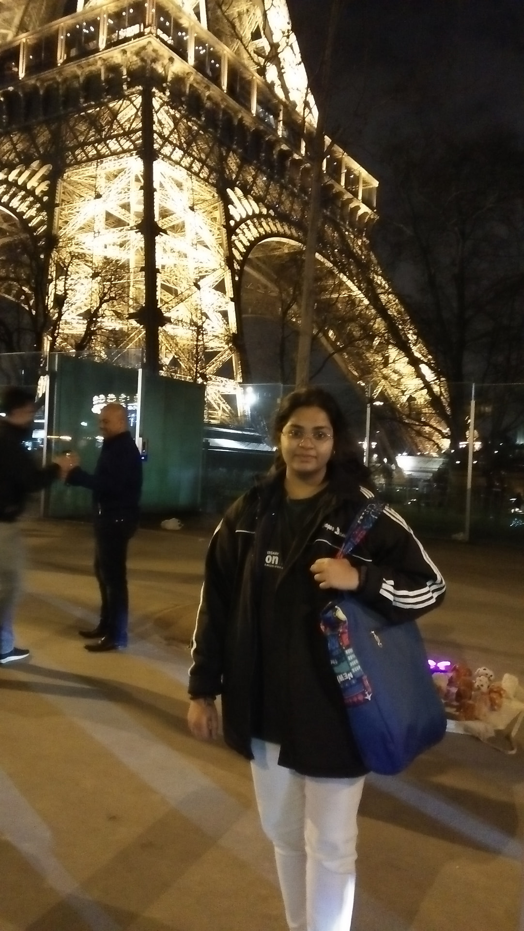 Abbi in front of the Eiffel Tower at night